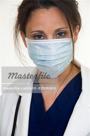 Brunette lady doctor wearing white lab coat with a stethoscope around shoulders and a blue mask over face