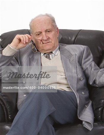 Portrait of a senior man thinking deeply in his office armchair.