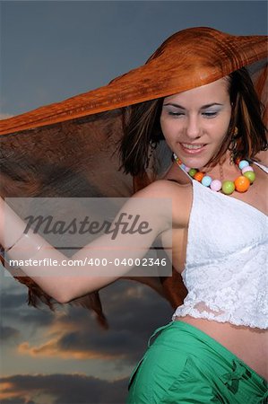 Portrait of young woman at sunset with happy expression