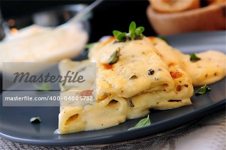 Cheese cannelloni pasta served on a plate with alfredo sauce