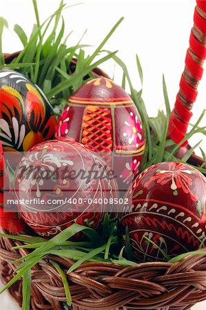 Close-up of Easter eggs in basket with grass
