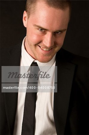 Portrait of a young businessman on dark background