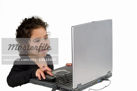 littel girl playing with laptop computer