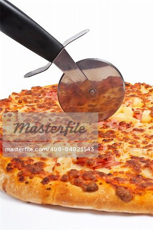 Tasty Italian pizza and cutter, isolated on white background. Shallow DOF