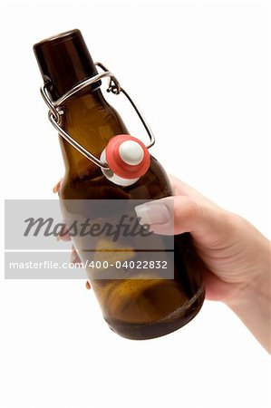 Female hand holding an opened beer bottle. Isolated on a white background.