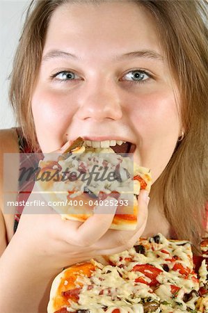 Beautiful no make-up girl eating a piece of Pizza