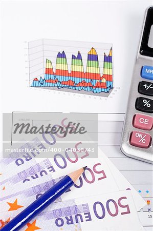 Calculator and pencil on earnings chart background. Shallow depth of field