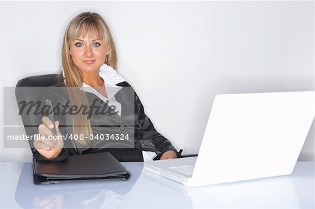 Beautiful and sexy bond business woman next to white table