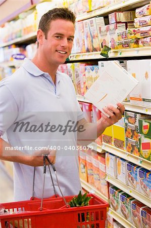 Young man grocery shopping in supermarket