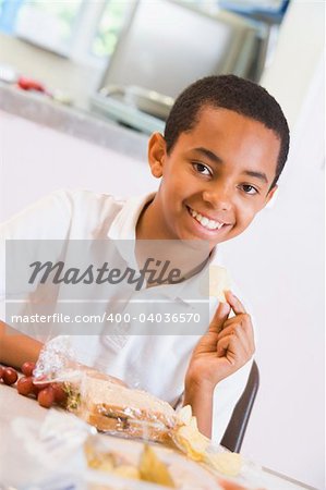 Schoolboy enjoying his lunch in a school cafeteria