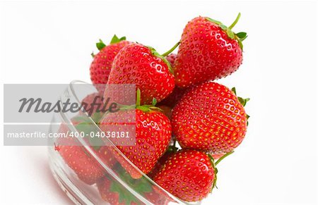 High key photo of fruit dish filled with nice red strawberries