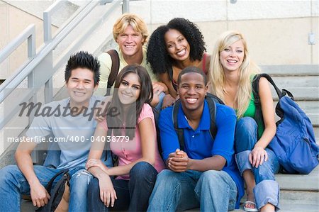 Group of six students outside sitting on steps