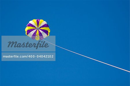 Parachute in the sky tether by cord