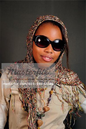 Portrait of young african female model posing with sunglasses