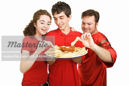 Handsome teen boy serves chips at a football party.  Isolated on white.