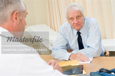 Man in doctor's office frowning
