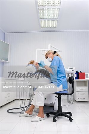 doctor works with patient in the dentist office