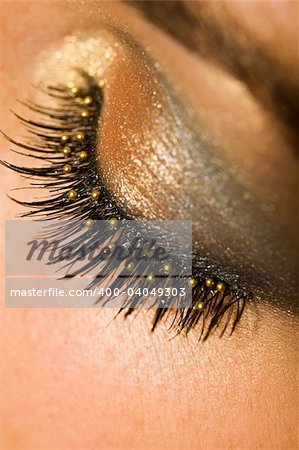 A macro close up of a beautiful woman's made up eye with false eyelashes