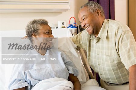 Senior Couple Smiling At Each Other In Hospital