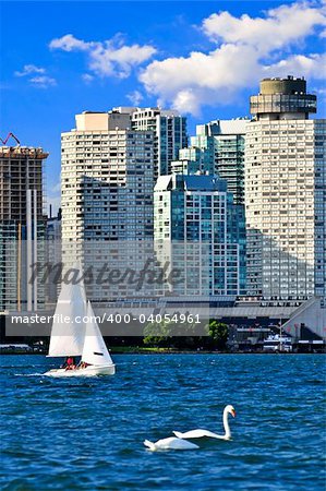 Sailboat sailing in Toronto harbour with scenic waterfront view