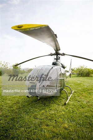 Landed helicopter on green field