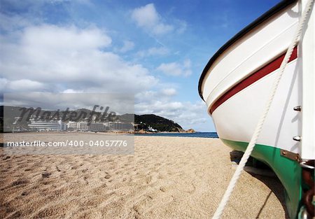 Lonely the boat on seacoast. Spain. Tossa