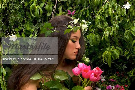 Mother Nature looking upon some of her many beautiful creations in her enchanted garden.  This indoor studio shoot is a compilation of many fresh flowers, grass, tree branches and bushes.