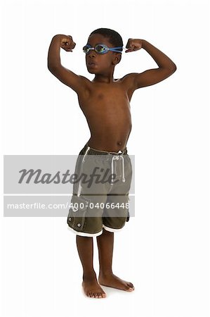 A young African American boy wearing swim trunks and goggles, and showing his muscles. Isolated on a white background.