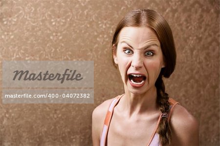 Screaming Young Woman in front of Gold wallpaper