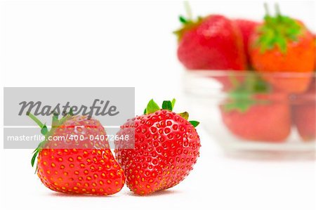 High key photo of fruit dish filled with nice red strawberries