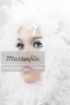 Girl with beautiful make up and white feathers