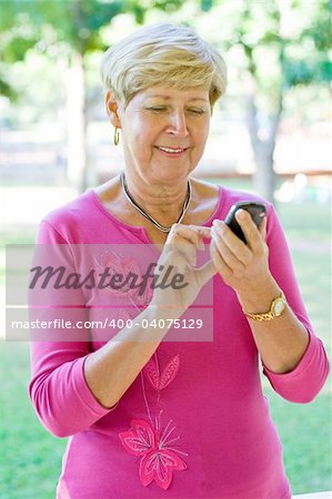 senior lady dial on a cell phone