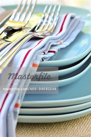 Table setting with stack of plates and cutlery