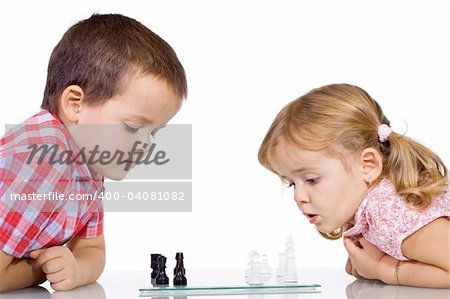 Concentrated kids playing chess - isolated