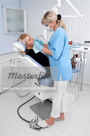 doctor works with patient in the dentist office