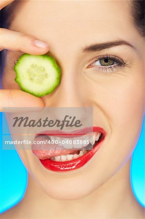 Portrait of beautiful woman with cucumber slice
