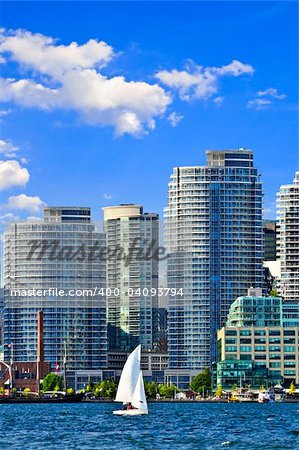 Sailboat sailing in Toronto harbour with scenic waterfront view
