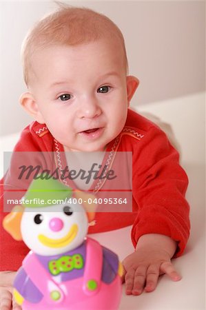 Portrait of cute newborn playing with toys