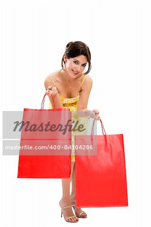 Mid adult woman holding red shopping bags on white background