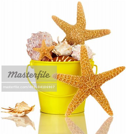 Starfish And Sea Shells In Colorful Yellow Beach Bucket Isolated On White