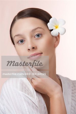 Portrait of young beautiful woman on pink background