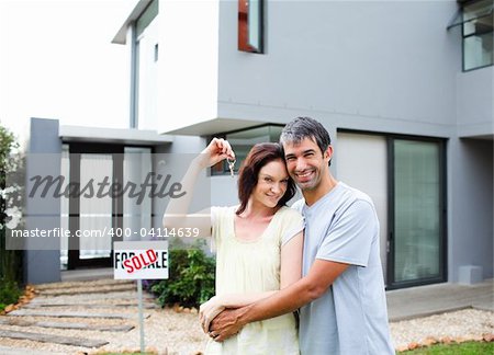 Happy young couple after buying house