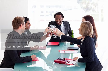 Happy businesspeople drinking champagne in office