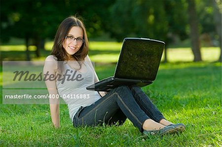 student with notebook in the park