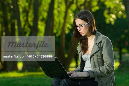 student with notebook in the park