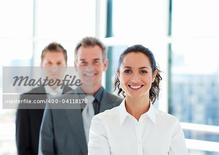 Smiling young businesswoman in front of her team