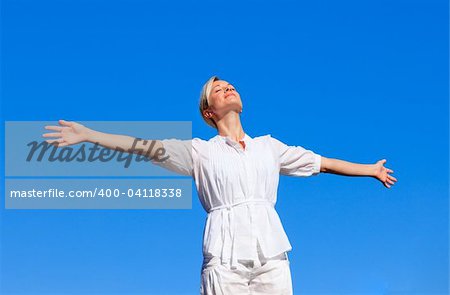 Happy woman with open arms outdoors