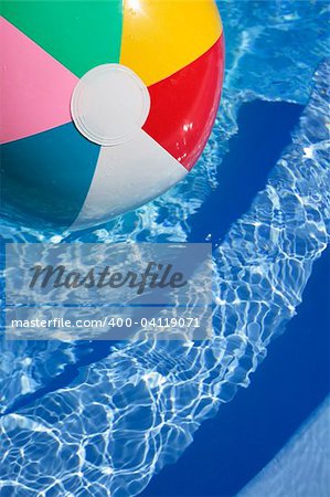 Multicolored Beachball in a beautiful blue swimming pool