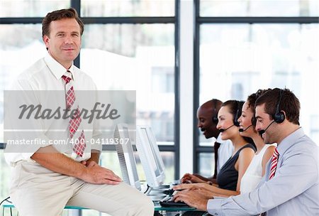 Confident senior manager working in a call center