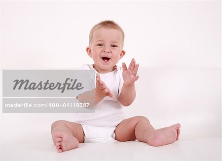 Portrait of cute baby laughing and applauding